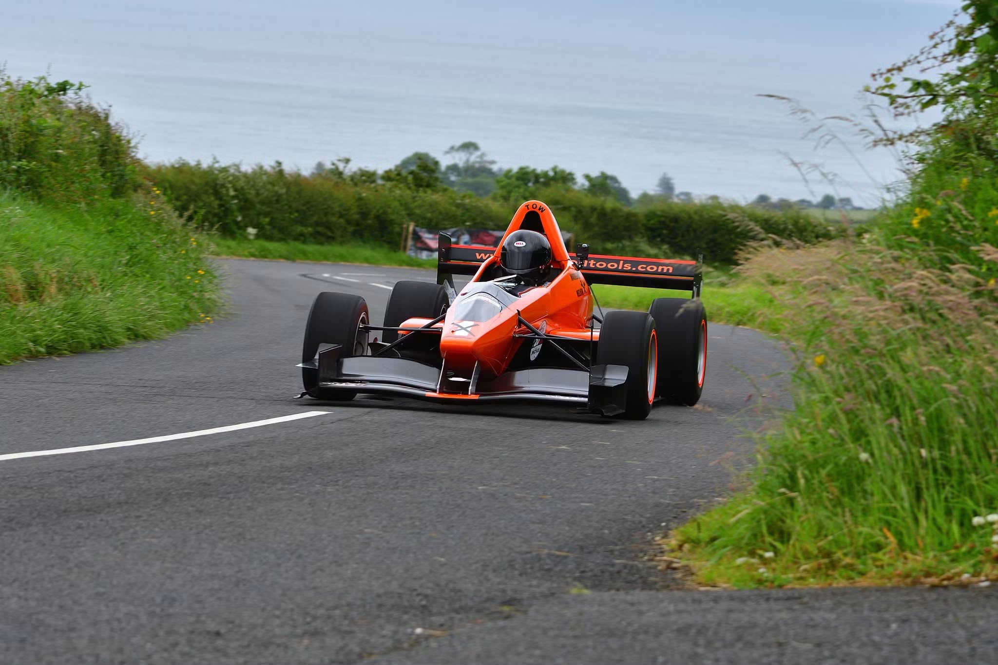Gary Warren competing in his orange Empire racing car